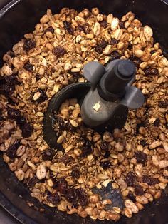 a food processor filled with granola and nuts