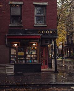 a book store sitting on the side of a street next to a tall red brick building