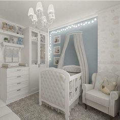 a baby's room with blue walls and white furniture