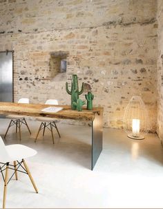 a table with two chairs next to it and a cactus on the table in front of it