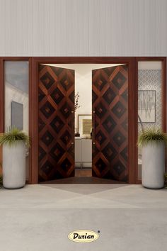 an open door with two planters in front of it