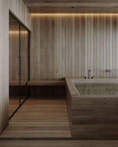 a large bath tub sitting next to a wooden wall