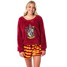 a woman is wearing a harry potter sweatshirt and shorts with her hand on her hip