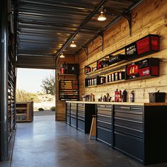 the inside of a garage with lots of shelves and drawers on the wall next to it