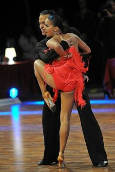 a man and woman dancing on a dance floor