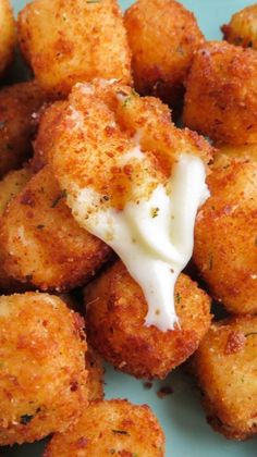 fried cheese cubes on a blue plate with ranch dressing in the middle and text overlay that reads easy fried cheese cubes