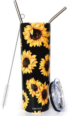 a black and yellow sunflower tumbler next to a metal straw holder with two straws in it