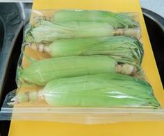 some type of vegetable wrapped in plastic on a tray