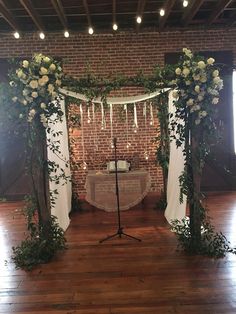 a wedding ceremony setup with white flowers and greenery