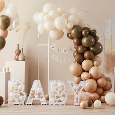 a baby shower with balloons and letters on the floor