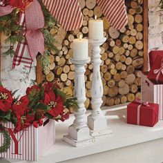 christmas decorations and candles on a mantle