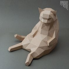 a paper sculpture of a cat sitting on the ground