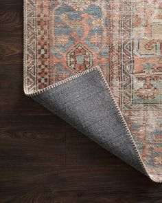 an area rug with wood flooring and wooden floors in the background is shown from above