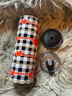 thermos and other items are laid out on a furry surface, including an orange polka dot design