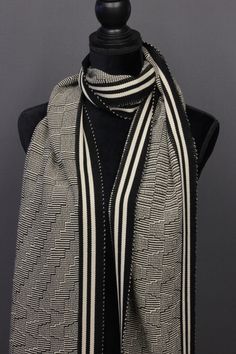 a black and white scarf on a mannequin