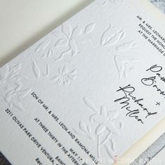 the wedding stationery is laid out on top of each other, with handwritten details