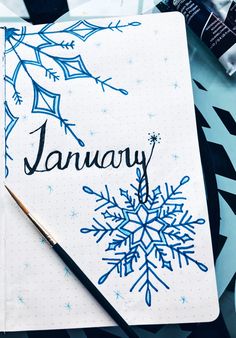 a snowflake is on top of a notebook with the word january written in it