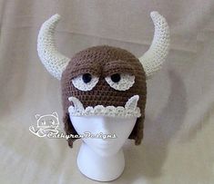 a crocheted hat with horns on top of a head