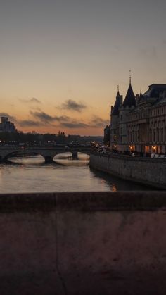 a bridge over a river with buildings in the background