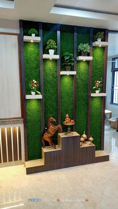 a living room filled with lots of green plants and potted plants on the wall