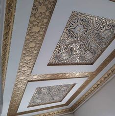 the ceiling is decorated with intricate gold and white designs, along with other decorative items