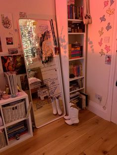 a room with bookshelves, shelves and pictures on the wall