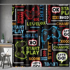 the shower curtain is decorated with colorful video game symbols and words that spell out, let's go