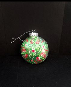 a green ornament sitting on top of a black surface