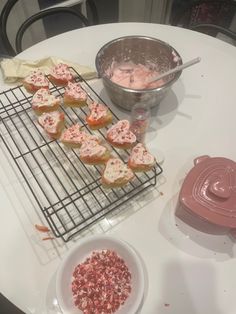 cupcakes cooling on the grill with pink icing and sprinkles