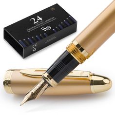 a gold fountain pen next to a black box