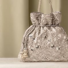 Silver Zardozi Sequin Flower Embroidered Satin Gray Wedding Potli Bag for Woman | Evening Cocktail Luxury Handcrafted Drawstring Purse Bag Size  : 10 x 8 Inches Package Content : 1 Pcs Designed with the heart, this beautiful Potli or batawa bag are eye catchy and made of premium material. Key Features: Embroidery art work This potli is good match with both Indian and western outfits and are superb for wedding and festive parties This would be best complement to your designer saree, lenhga or any other kind of dress This is the combination of traditional and modern embroidery work This is enough to keep your accessories and all needed essentials and it can be a best gift for any woman. Elegant Silver Embroidered Bags, Silver Embroidered Clutch Bag, Silver Embellished Bags For Wedding, Elegant Embroidered Handheld Bag, Elegant Handheld Embroidered Bag, Embellished Silver Bags For Wedding, Silver Embellished Wedding Bag, Silver Embellished Wedding Bags, Embellished Silver Wedding Bags