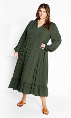 Radiate confidence in the Alena Maxi Dress. Flowing over your curves gorgeously with lightweight fabrication and a ruffle hemline, this dreamy look elevates your everyday collection. Complete with a waist definition, this dress achieves style goals effortlessly. Key Features Include: - V-neck notched neckline - Full length sleeves with elastic cuffs - Waist definition - Ruffle hemline - Lightweight fabrication - Maxi length Partner with strappy wedge heels. | Plus Size Dress Alena Midi in Khaki, Strappy Wedge Heels, Radiate Confidence, Denim Jeans Fashion, Notched Neckline, Designer Midi Dresses, Date Night Dresses, Khaki Dress, Long Sleeve Midi, Long Sleeve Midi Dress