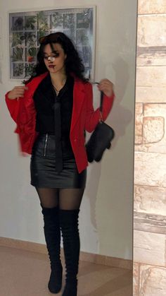 a woman in black tights and red jacket