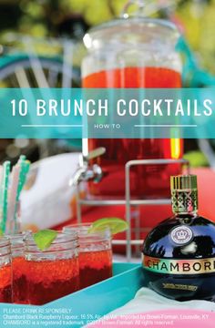 a bottle of alcohol sitting on top of a blue tray next to two glasses filled with drinks