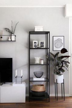 a living room filled with furniture and a flat screen tv sitting on top of a wooden floor