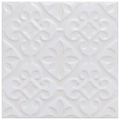 a white tile with an intricate design on it