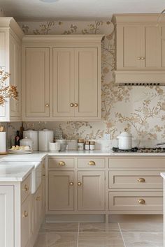 a kitchen with beige cabinets and white counter tops