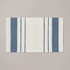 a blue and white striped rug on a gray background