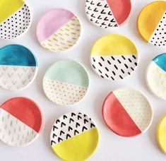 colorful plates with different designs on them sitting next to each other in the shape of circles