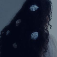 the back of a woman's head with buttons on it