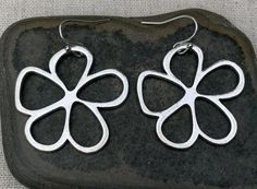 Unique, stylish and cool mod flower earrings.  They are simple and refined but also chic and fun.  These earrings are timeless and perfect for everyday wear.The earrings measure 1 3/8” long by 1 3/8” wide and are made from plated silver.  They hang from simple silver ear wire hooks.  Overall drop length is 1 1/2”.I have a matching necklace in my shop, if you would like the whole set.  Here is a direct link............Thanks for stopping by!  Please take a moment and visit the rest of my Etsy sto Spring Flower Shaped Nickel Free Earrings, Modern Metal Earrings For Spring, Spring Flower-shaped Nickel-free Earrings, Modern Spring Earrings For Gift, Spring Flower Charm Earrings For Everyday, Nickel-free Flower Earrings For Spring, Modern Flower Shaped Earrings For Gift, Everyday Flower Earrings With Spring Charm, Everyday Flower Earrings With Charm For Spring