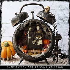 an old fashioned alarm clock decorated with skeletons and pumpkins is featured in this image