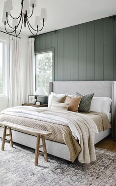 a bedroom with green walls and white bedding