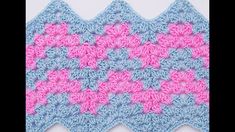 a crocheted blue and pink square with two rows of squares in the middle