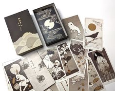 an assortment of cards are displayed on a white surface with black and gold inks