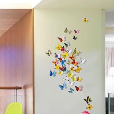 there are many butterflies on the wall in this room, and it looks like they have been made out of paper