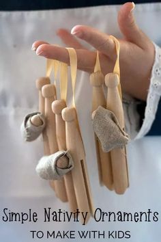 a hand holding several wooden pegs with clothes pins attached to them and text overlay that reads simple nativity ornaments to make with kids