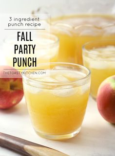 three glasses filled with fall party punch next to an apple and cinnamon stick on the table