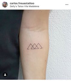 a small triangle tattoo on the arm