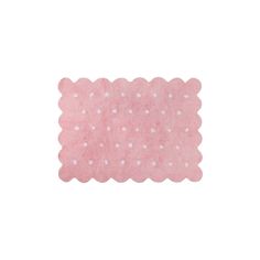 a pink rug with white dots on it